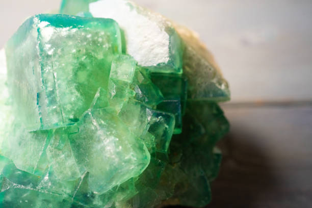 istock Green fluorite rough stone on wooden board 1265143898