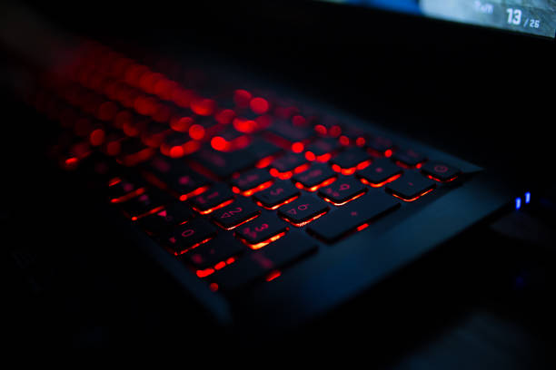 istock Red backlit keyboard close up. Gaming laptop 1265143936