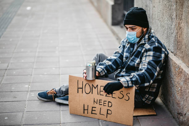istock Homeless man sitting and begging for help 1265144179