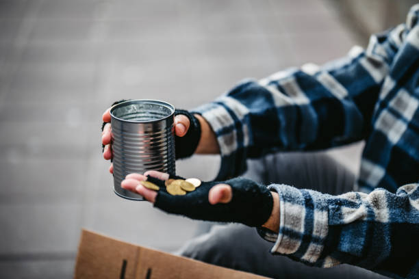 istock Beggar holding a can for money 1265144186