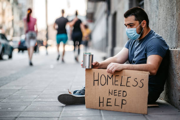 istock Homeless man sitting and begging for help 1265144256
