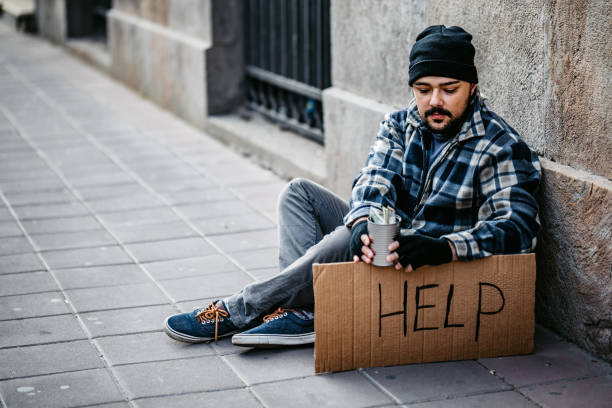 istock Homeless man sitting and begging for help 1265144723