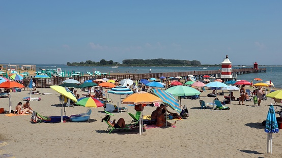 Lignano Sabbiadoro, Italy. August 10, 2020. View of the beach of Lignano Sabbiadoro on an august sunny day. the tourism industry tries to recover after the covid 19 emergency