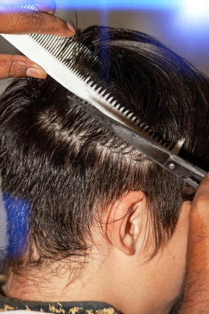 istock young man cutting his hair 1265150875