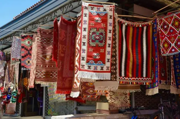 Traditional Balkan rugs and bags for sale at market in Skopje, Macedonia