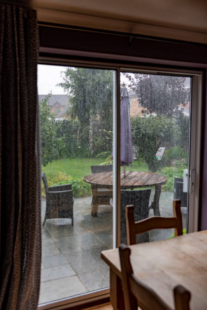 istock Back garden viewed through a patio door on a rainy day 1265151685