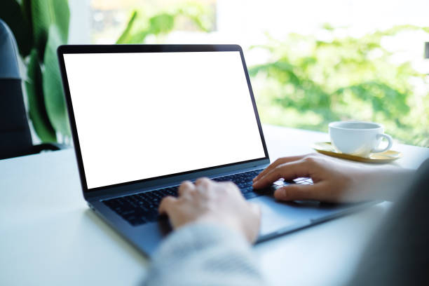 istock a businesswoman using and typing on laptop keyboard with blank white desktop screen in the office 1265154691