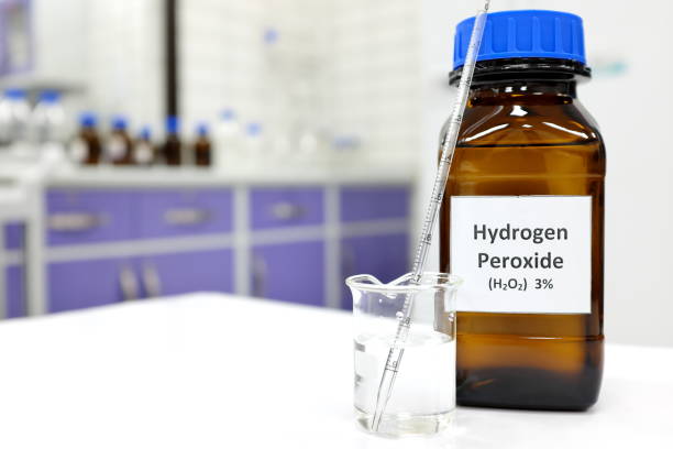 istock Selective focus of hydrogen peroxide solution in brown amber bottle. Blur laboratory background with copy space. 1265157185