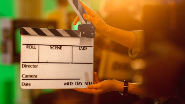 istock Close up Shot On Film Studio Set Young Camera Assistant Holds Empty Clapperboard. In the Background Director Shooting Green Screen Scene. History Costume Drama Movie. 1265157292