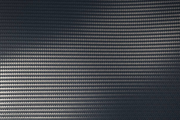 istock Light reflection on surface of grey woven carbon fibre composite material. 1265157302