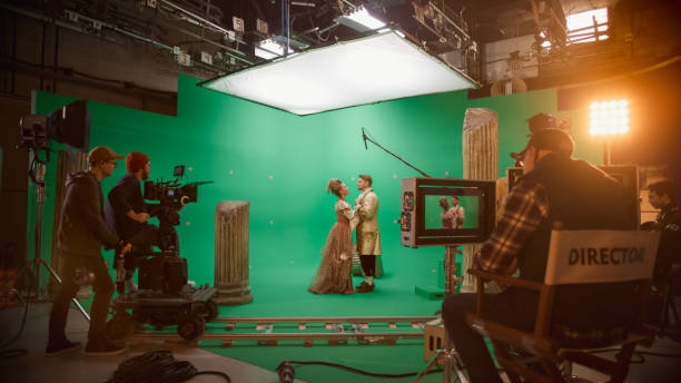 istock Film Studio Set: Shooting Green Screen Scene with Two Talented Actors Wearing Renaissance Clothes Talking, Embraces. Period Drama Movie Backstage 1265157473