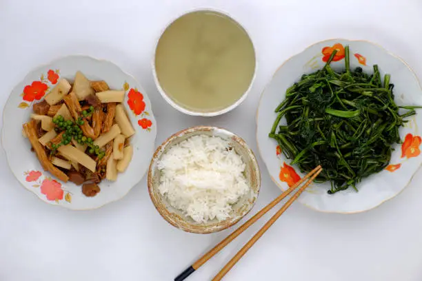 Top view vegan daily meal for lunch, boiled water spinach, skin tofu and copra cook with sauce, simple vegetarian Vietnamese food that nutrition and good for health