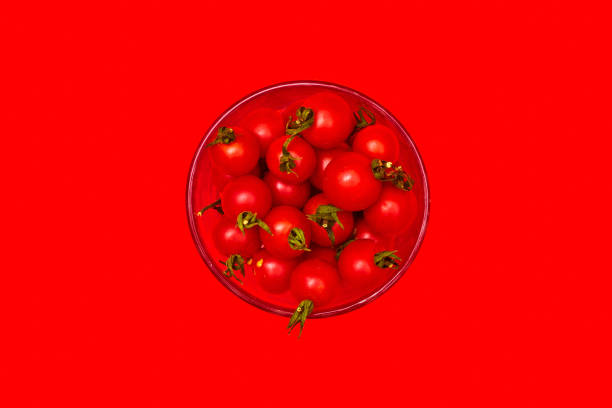 istock cherry tomatoes in a glass on a red background top view one 1265157650