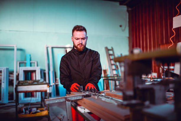 istock Bearded Male Worker Shaping Metal Plates In Workshop 1265159197