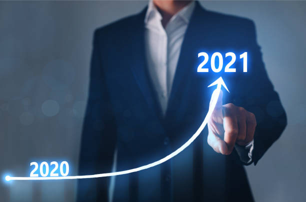 istock Businessman pointing arrow graph corporate future growth year 2020 to 2021. Development to success and growing growth concept. 1265159212