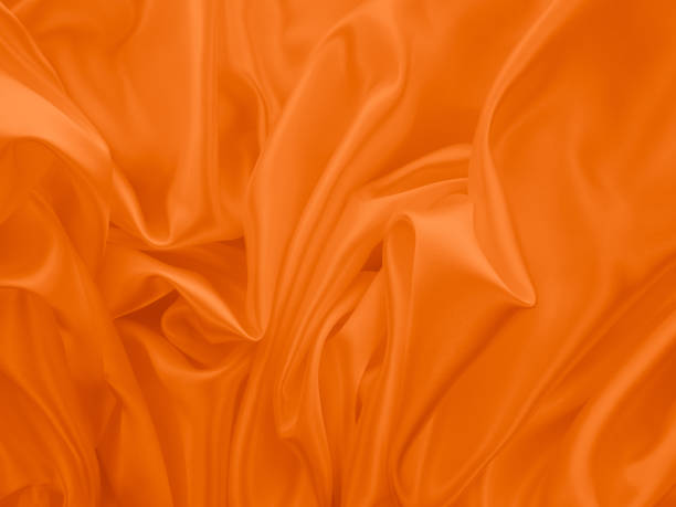 istock Beautiful elegant wavy orange satin silk. 1265159965