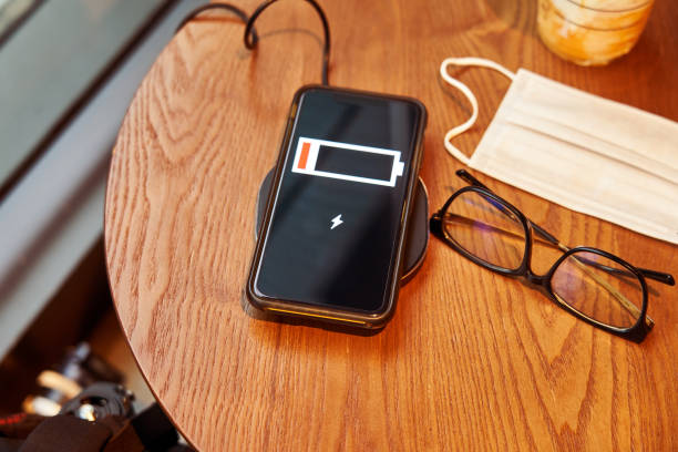 istock Wireless charging of smartphone on restaurant table, concept of charging sharing 1265160259