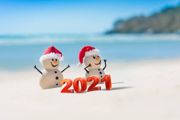 istock Sandy Christmas Snowmen are celebrating Christmas 1265161616