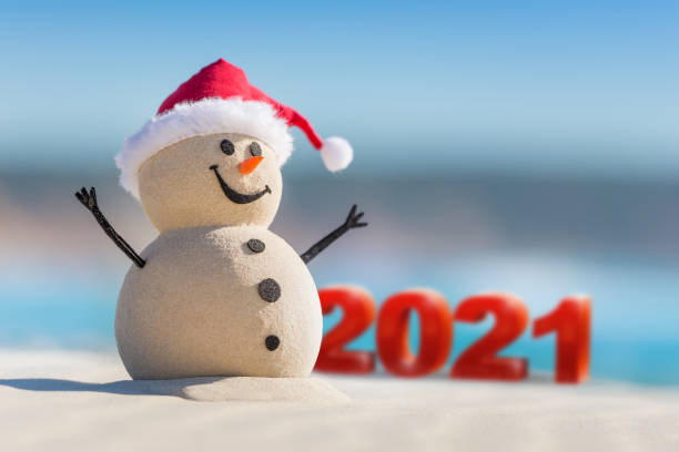 istock Sandy Christmas Snowman is celebrating Christmas 1265161828