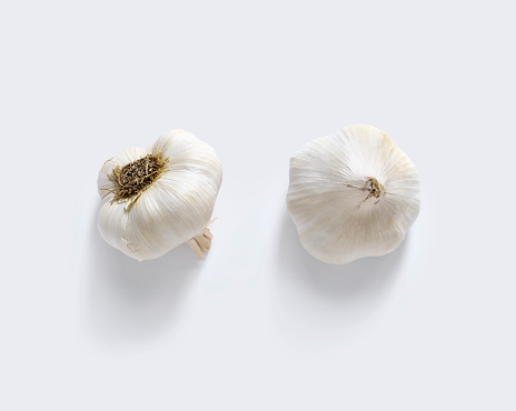 Close-up, head of garlic on a white background. Heads and cloves of garlic on a white background. Isolate
