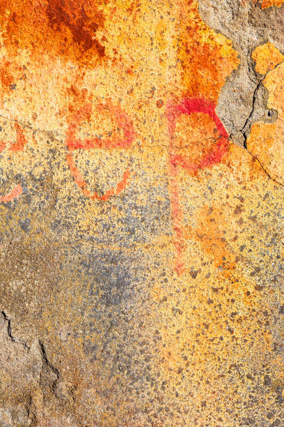 istock Great colorful background or texture. Abstract concrete is aged with cracks, scratches and remnants of old paint in different shades. Rough concrete surface 1265165486