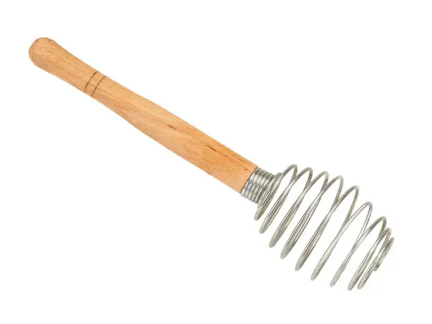 Houseware: steel whisk with wooden handle isolated on a white background