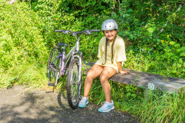 istock Twelve year old girl cycling in countryside 1265167521