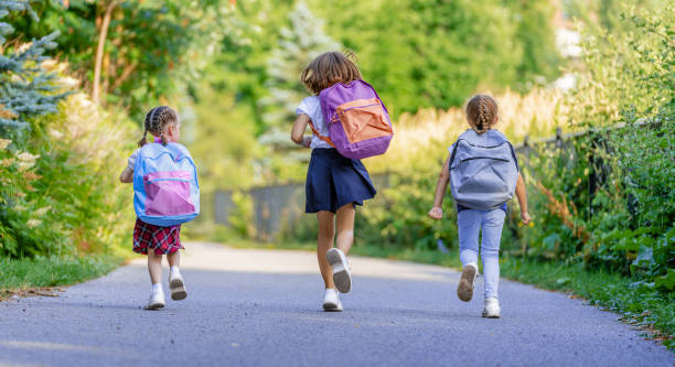 istock Girls with backpack are going to school 1265167624