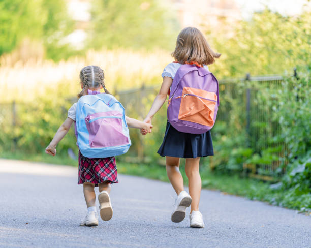 istock Girls with backpack are going to school 1265167631