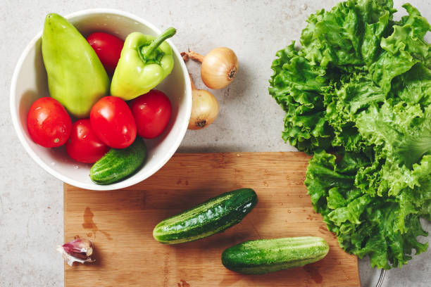 istock Fresh vegetables on a cutting board, salad ingredients. 1265168455
