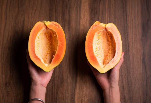 istock Sliced papaya fruit on a wooden table top view 1265171974