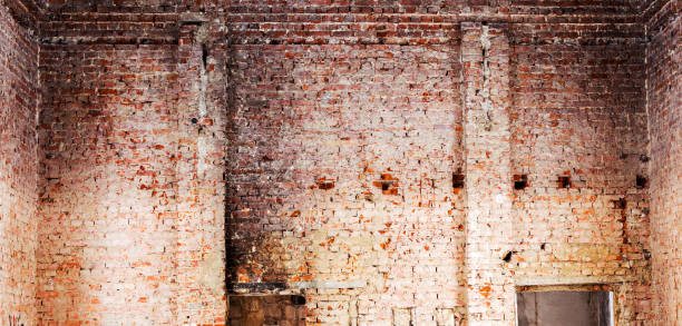 istock Old building falling apart with broken windows, walls covered with cracks and scratches 1265174305