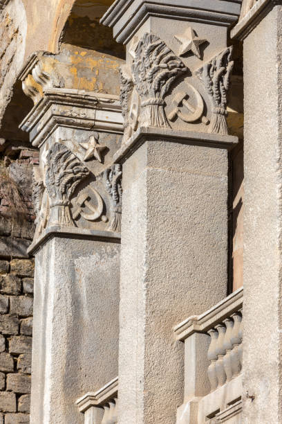 istock Old building falling apart with broken windows, walls covered with cracks and scratches 1265174351