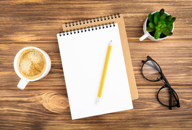 istock Notebook with pencil, glasses, plant and coffee. 1265174866