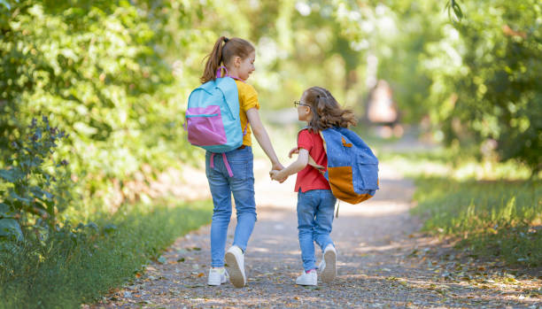 istock Girls with backpack are going to school 1265175447