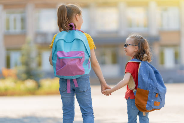 istock Girls with backpack are going to school 1265175464