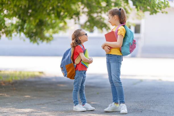 istock Girls with backpack are going to school 1265175500