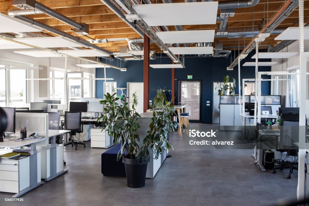 Large open plan office interior Interior of modern open plan office with no people. Interior of of a large place of work with coworking desks. Office Stock Photo