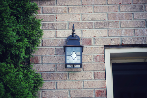 An outdoors light fixture on the exterior of a home