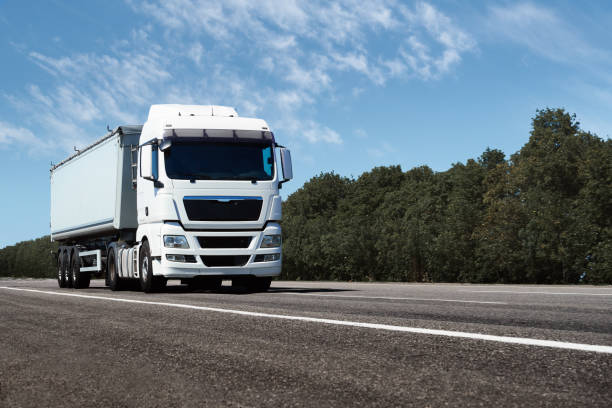 istock truck on the road, front view, empty space on a white container - concept of cargo transportation, trucking industry 1265180812