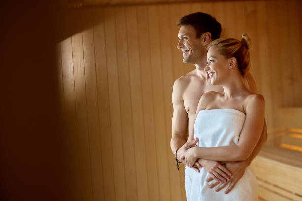 istock Smiling couple standing embraced in a sauna at the spa. 1265182190