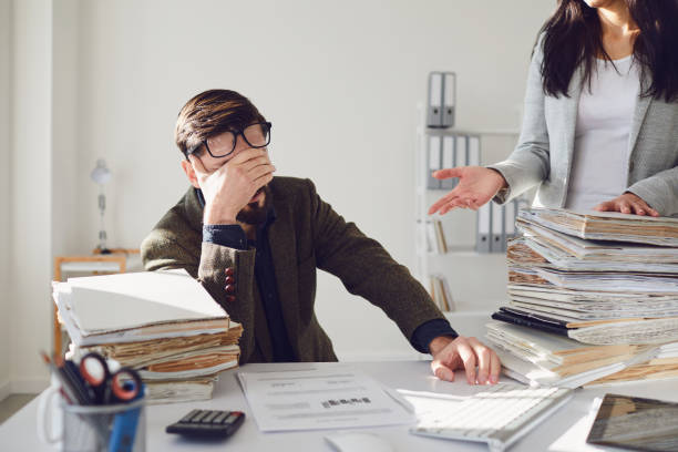 Worker businessman tired upset indignant unhappy sitting at workplace work in the office.