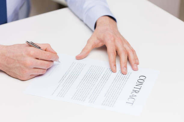 istock close up of male hands signing contract document 1265182697