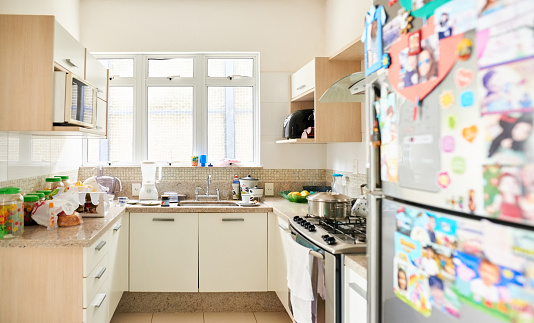 Shot of a brightly lit domestic kitchen with white furniture