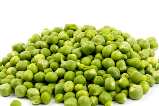 istock Green young peas, isolated on white background. Close-up. Top view 1265183902