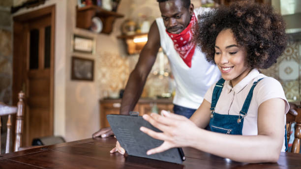 istock Afro couple working from home in the kitchen and having breakfast together, during COVID-19 1265183908