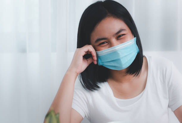 istock Young beautiful smiling woman wearing mask working from home  while quarantine from coronavirus  outbreak 1265183933