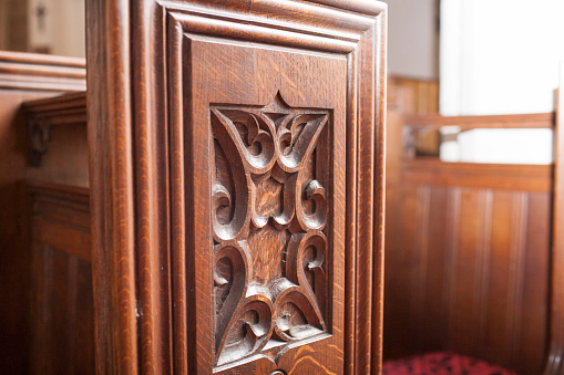 Detail of a carved wooden pew end in an English church