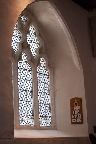 istock Plain glass arch window with hymn numbers on a board 1265185354