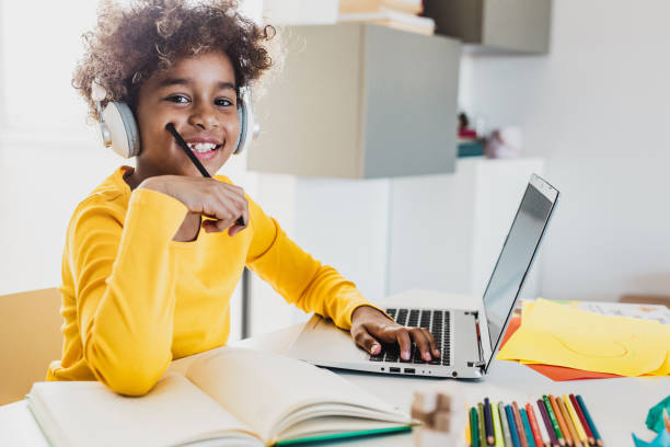 istock Young girl at home studying with laptop 1265185428